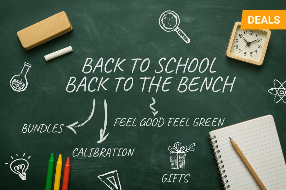  A green chalkboard with the phrase “Back to School, Back to the Bench” written in white chalk-style text. Surrounding the message are school and science-themed chalk illustrations, including a magnifying glass, beaker, atom symbol, paper airplane, light bulb, and gift box. Additional words like “BUNDLES,” “CALIBRATION,” “GIFTS,” and “FEEL GOOD FEEL GREEN” are also written. Real school items—crayons, a spiral notebook with a pencil, a chalkboard eraser, a piece of chalk, and a small alarm clock—are placed around the chalkboard. A yellow “DEALS” tag is in the top right corner.